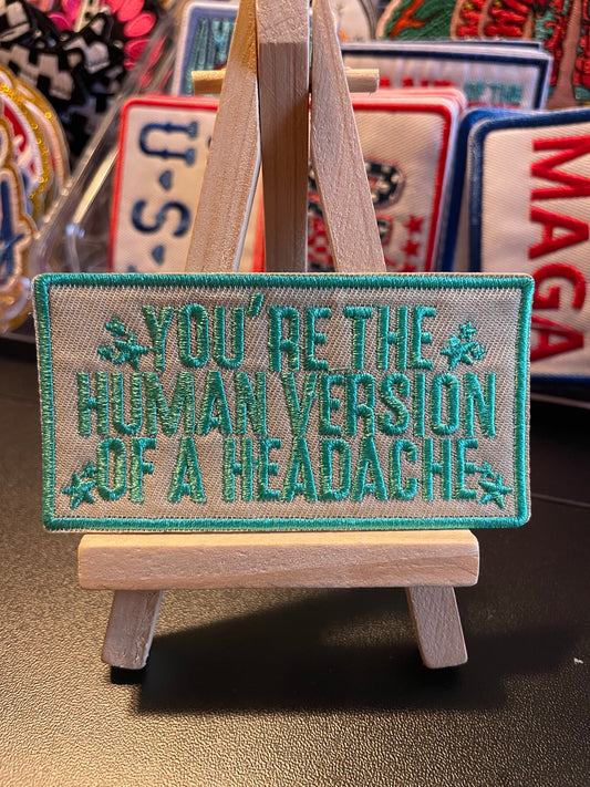 Human version of a headache iron on embroidered patch